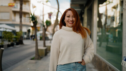 Young redhead woman smiling confident standing at street