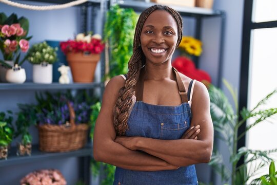 African american woman florist smiling confident standing with arms crossed gesture at flower shop