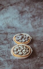 Blueberry cakes with blue berries on dark vintage background