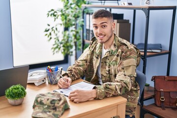 Young hispanic man army soldier signing contract at office