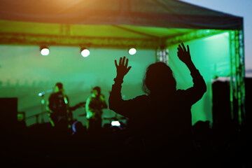 Fototapeta na wymiar Rock band performance, happy girl silhouette.