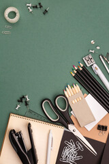 stationery items around of image on green background. Back to school background, banner with copy space. Student's or engineer's supplies. Office objects on dark green background. Calculator, keyboard - 568851802
