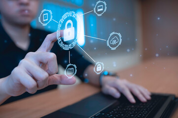 Businessman touch virtual screen on computer,Cyber secutiry concept,A shield protects the laptop from virus from the internet.