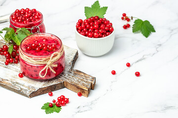 Preserved berry Homemade jam. Glass jar with red currant jam on a light background. Long banner format. top view