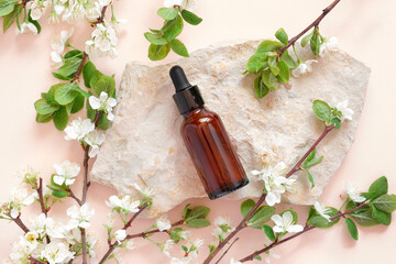 Natural oil cosmetics. Dropper glass Bottle Mock-Up. Oily cosmetic pipette on a stone Podium on pink background. White flowers, soft shadow. Scene, Showcase, display. Minimal design. Top view Flat lay