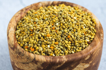 Bee pollen or perga textured background . Raw brown, yellow, orange and blue flower pollen grains or bee bread texture pattern. Healthy food supplement