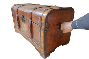 hand pulls an old dowry chest, cut out