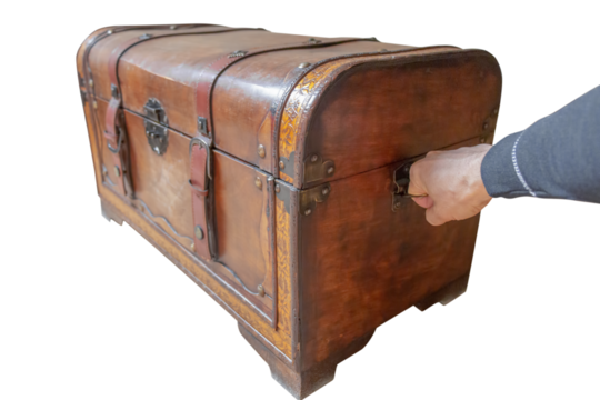 hand pulls an old dowry chest, cut out