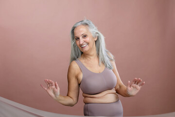 Portrait of senior woman in lingerie, studio shoot.