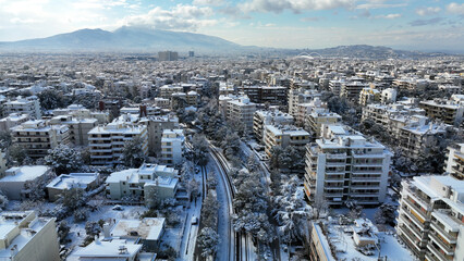 Aerial drone photo of main train station of Marousi centre and district covered in snow as seen at winter, North Athens, Attica, Greece