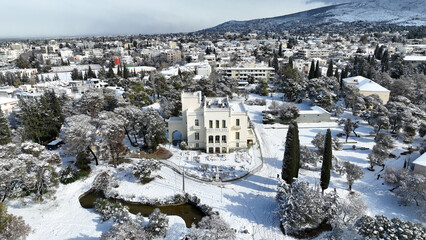 Aerial drone photo of beautiful park of Syggrou with rare trees and beautiful nature covered in snow as seen in winter, Marousi, North Athens, Greece