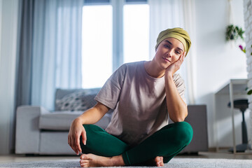 Young woman with cancer resting after taking yoga.