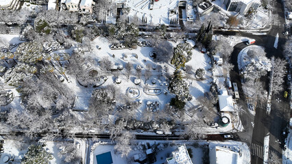 Aerial drone photo of main park of Kifisia district or Alsos Kifisias covered in snow during winter...