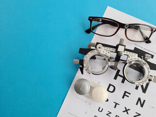 Collection of eyeglasses with vision chart and soft contact lenses