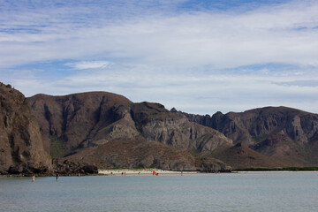 Pacific ocean beach with mountains in the background