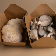 Close-up of beautiful natural organic oyster mushrooms and lion mane in ecological craft boxes