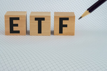 ETF Exchange Traded Fund on chart paper with black pencil