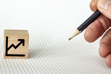 Rising equities chart icon with pencil on graph paper