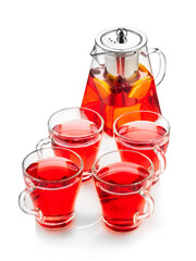 Red fruit tea with oranges, kiwi, strawberries in a glass teapot and cups. On a white background , isolate