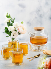 Green tea in a glass teapot and cups. On a white background. Tea concept.