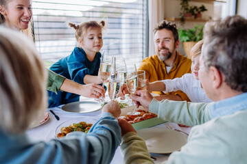 Happy family toasting before the Easter dinner.