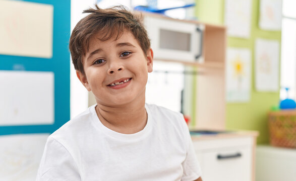 Adorable hispanic boy smiling confident standing at kindergarten