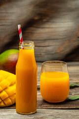 Fresh tropical fruit smoothie mango juice in a glass jar with a tube. place for text