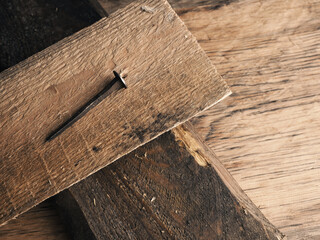 Wooden cross with an old rusty nail symbolizes the crucifixion of Jesus. Easter concept