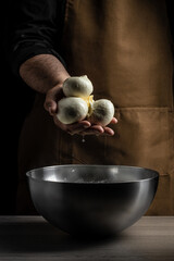 man holding a mozzarella in his hands. Italian hard cheese silano or caciocavallo, mozzarella