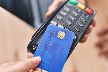 Young woman ecommerce business worker collect using credit card and data phone at office