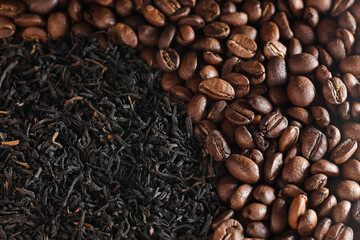 tea or coffee? coffee beans and natural black tea top view. coffee vs tea. choice of drink concept