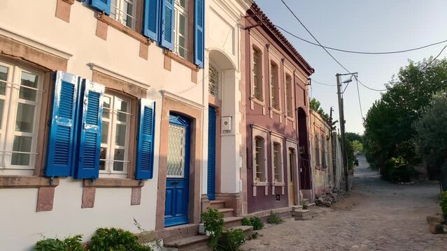 Footage of old, historical stone houses in Cunda island of Ayvalik district of Turkey. It is a sunny summer day.