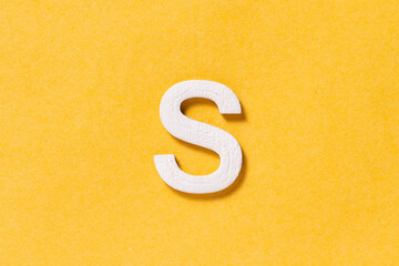Letter S of the alphabet isolated on yellow background, top view