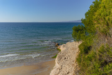 Landscape of the beach, blue sea and sky, rock and trees