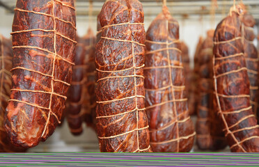 Thighs hanging in a cellar of the factory. Maturing room of hams in the factory