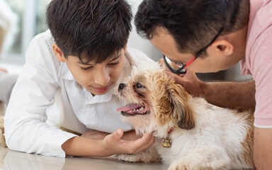Portrait of family, father, son, dog staying together, showing love, warm expression at cozy or comfortable home. Lifestyle, Healthcare Concept.