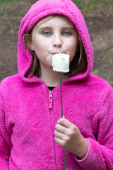 Marshmallow eating blue eyed girl in pink 