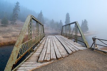 Old wooden bridge on a fogy morning