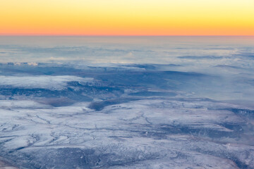 Obraz na płótnie Canvas Aerial view of the Peak District, during sunset in winter with snow