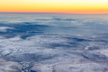Aerial view of the Peak District, during sunset in winter with snow