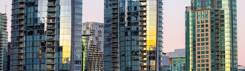 Fototapeta na wymiar Residential Highrise Apartment Buildings in Coal Harbour, Downtown Vancouver, British Columbia, Canada. Winter Sunrise