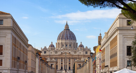Fototapeta na wymiar St. Peter's Basilica in urban streets of Downtown Rome, Italy. Cloudy Sky.