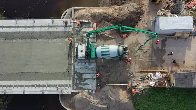 Drone above bridge construction restoration concreting works, aerial view