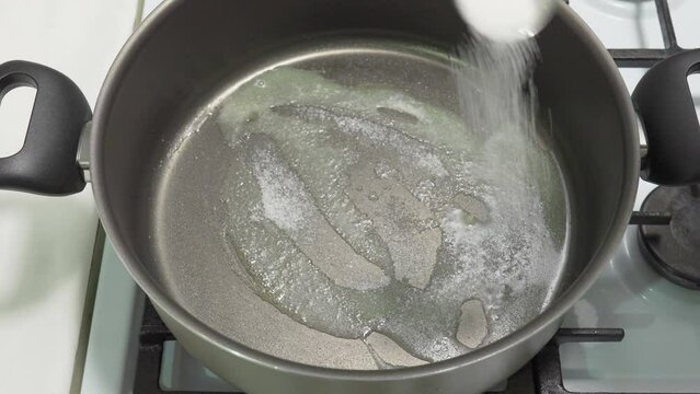 Put a tablespoon of sugar in a pan with melted butter. High quality 4k footage