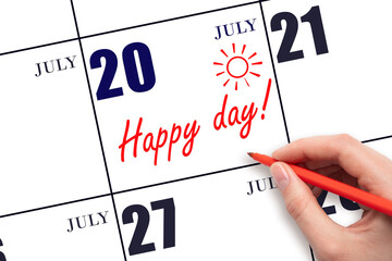 Hand writing the text HAPPY DAY and drawing the sun on the calendar date July 20