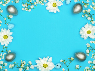 Blue Easter background. Flowers and eggs. Bright space for your text
