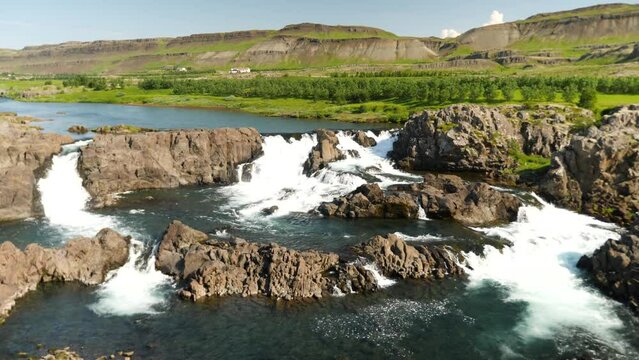 Glanni Waterfall during summer in Iceland. Magical Icelandic landscape with lush green bushes. High quality 4k footage