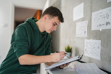 Young man caucasian teenager learning study at home education concept