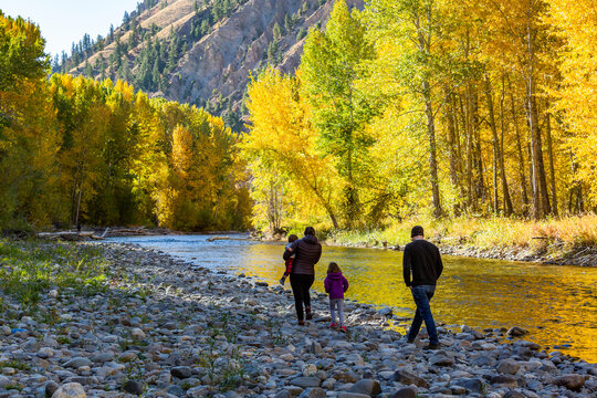 USA, Idaho, Hailey, Family admires fall along river in autumn&nbsp;