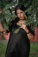 Portrait of a beautiful dark-haired girl in rowan foliage.